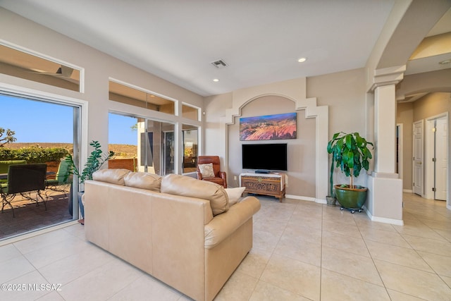 1861 E Crown Ridge Way, Oro Valley, AZ 85755 - living room featuring light tile patterned flooring, recessed lighting, ornate columns, and baseboards