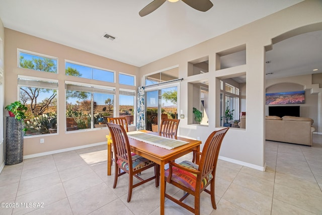 1861 E Crown Ridge Way, Oro Valley, AZ 85755 - dining room featuring light tile patterned flooring, ceiling fan, baseboards, and arched walkways