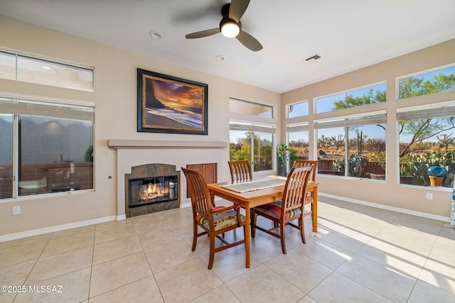 1861 E Crown Ridge Way, Oro Valley, AZ 85755 - dining room with ceiling fan, a tile fireplace, tile patterned floors, and baseboards