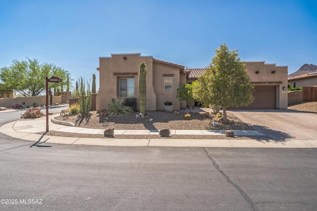 3022 S Open Range Way, Tucson, AZ 85713 - pueblo-style house featuring decorative driveway, stucco siding, and an attached garage