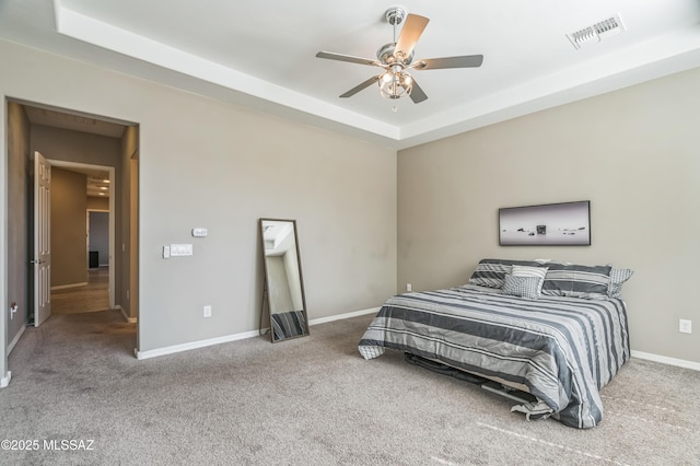 3022 S Open Range Way, Tucson, AZ 85713 - bedroom with carpet flooring, a tray ceiling, baseboards, and ceiling fan