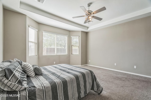3022 S Open Range Way, Tucson, AZ 85713 - carpeted bedroom featuring baseboards, a tray ceiling, and ceiling fan
