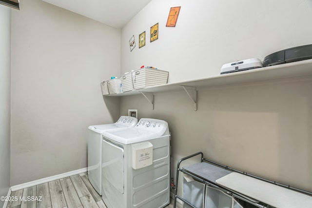 3022 S Open Range Way, Tucson, AZ 85713 - washroom with washing machine and clothes dryer, baseboards, and wood finished floors