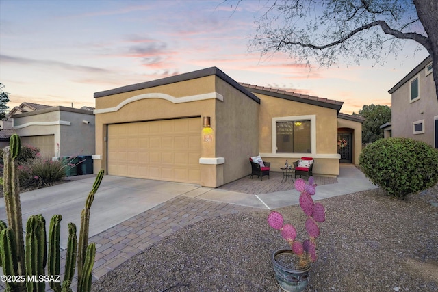 14511 S Camino Tierra Luna, Sahuarita, AZ 85629 - view of front of property with stucco siding, a garage, driveway, and a tiled roof