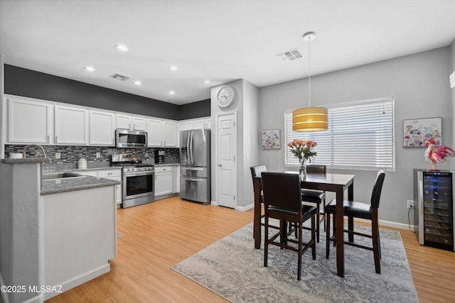 14511 S Camino Tierra Luna, Sahuarita, AZ 85629 - kitchen with stainless steel appliances, a sink, beverage cooler, recessed lighting, and white cabinetry