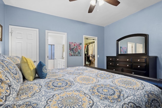 14511 S Camino Tierra Luna, Sahuarita, AZ 85629 - bedroom featuring a walk in closet, a closet, connected bathroom, and a ceiling fan