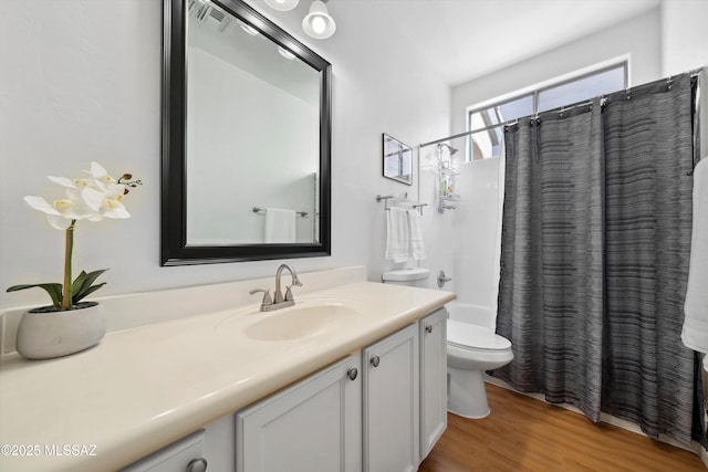 14511 S Camino Tierra Luna, Sahuarita, AZ 85629 - full bathroom featuring vanity, toilet, wood finished floors, and shower / tub combo with curtain