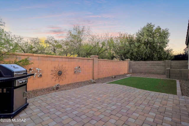 14511 S Camino Tierra Luna, Sahuarita, AZ 85629 - patio terrace at dusk featuring a patio, grilling area, and a fenced backyard