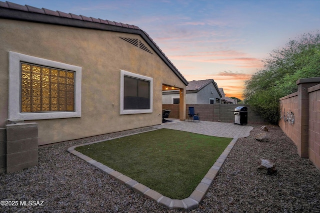 14511 S Camino Tierra Luna, Sahuarita, AZ 85629 - back of house at dusk featuring a patio and stucco siding