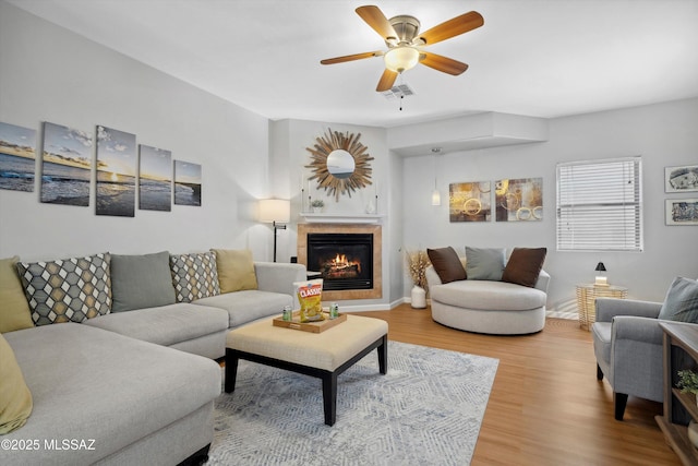 14511 S Camino Tierra Luna, Sahuarita, AZ 85629 - living room with a fireplace, wood finished floors, and a ceiling fan