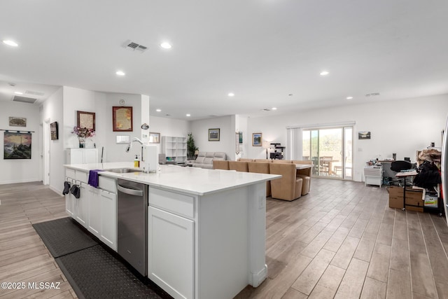 5568 W Summer Vw Dr, Marana, AZ 85658 - kitchen with dishwasher, open floor plan, a kitchen island with sink, light wood-type flooring, and white cabinets