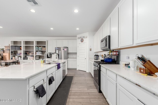 5568 W Summer Vw Dr, Marana, AZ 85658 - kitchen with appliances with stainless steel finishes, a sink, light wood-style flooring, recessed lighting, and white cabinetry