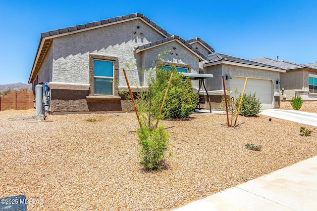 5568 W Summer Vw Dr, Marana, AZ 85658 - view of front of house featuring stucco siding, a garage, driveway, and a tile roof