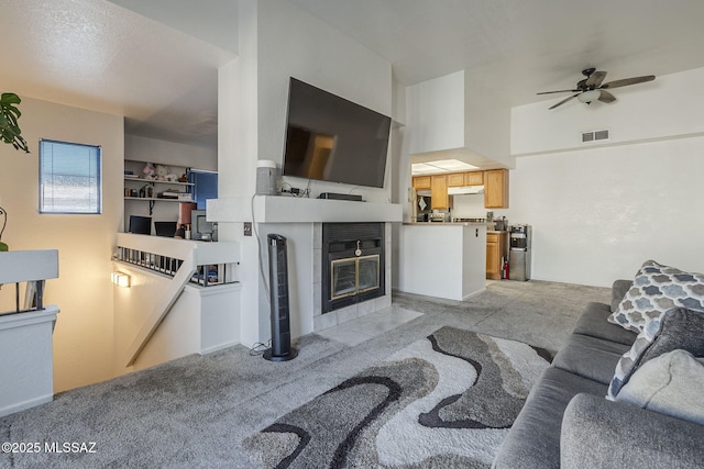 7913 E Colette Cir Unit 44, Tucson, AZ 85710 - living area with ceiling fan, a tile fireplace, and light colored carpet