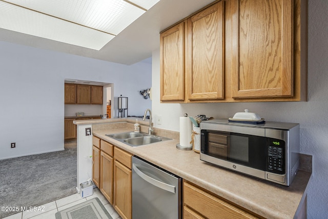 7913 E Colette Cir Unit 44, Tucson, AZ 85710 - kitchen with appliances with stainless steel finishes, a sink, light countertops, light colored carpet, and light tile patterned floors