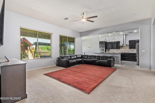11874 N Raphael Way, Tucson, AZ 85742 - living room with a ceiling fan, light colored carpet, and baseboards