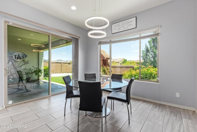 11874 N Raphael Way, Tucson, AZ 85742 - dining area with healthy amount of natural light, baseboards, and recessed lighting