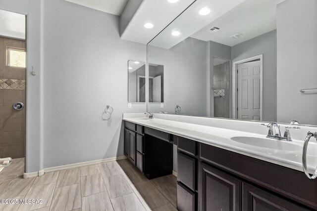 11874 N Raphael Way, Tucson, AZ 85742 - full bathroom with double vanity, a walk in shower, baseboards, and recessed lighting
