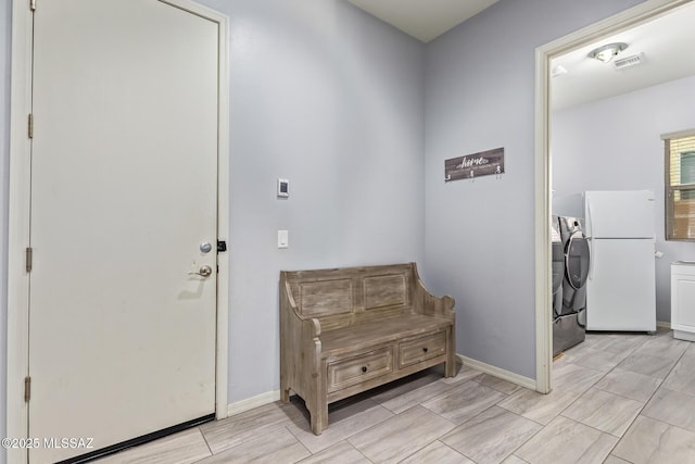 11874 N Raphael Way, Tucson, AZ 85742 - foyer entrance featuring washer and clothes dryer and baseboards