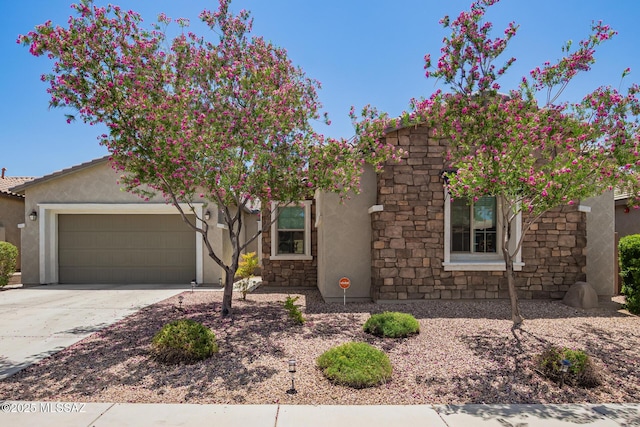 11874 N Raphael Way, Tucson, AZ 85742 - view of front facade with a garage, stucco siding, concrete driveway, and stone siding