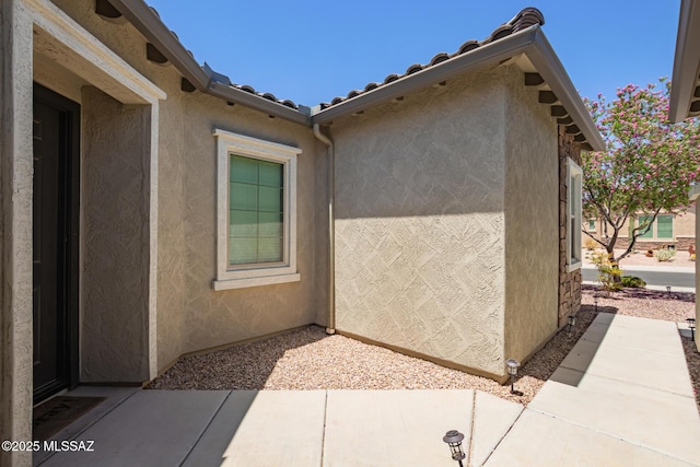 11874 N Raphael Way, Tucson, AZ 85742 - view of property exterior featuring stucco siding, a tiled roof, and a patio