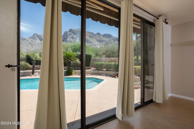 9710 N Cliff View Pl, Oro Valley, AZ 85704 - doorway to outside with a mountain view, concrete flooring, and baseboards