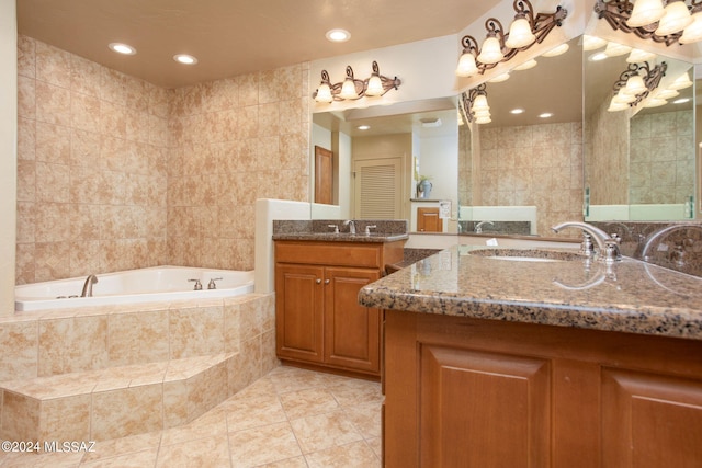 9710 N Cliff View Pl, Oro Valley, AZ 85704 - bathroom with tile patterned flooring, two vanities, a bath, recessed lighting, and tile walls