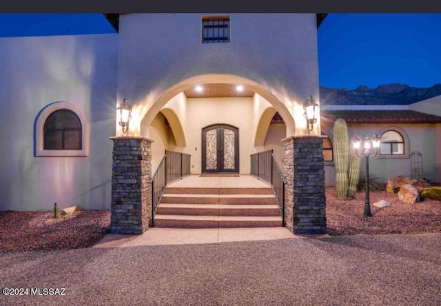 9710 N Cliff View Pl, Oro Valley, AZ 85704 - exterior entry at twilight with french doors and stucco siding