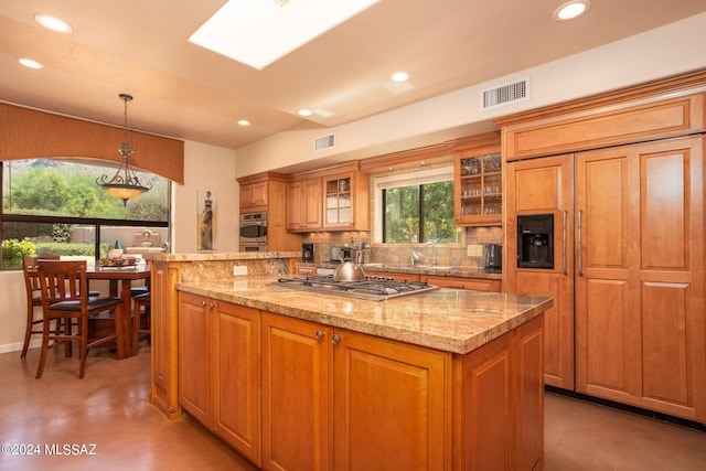 9710 N Cliff View Pl, Oro Valley, AZ 85704 - kitchen featuring appliances with stainless steel finishes, a center island, recessed lighting, backsplash, and brown cabinets