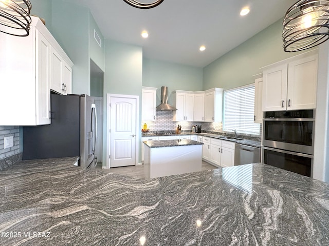 3335 E Canyoneer Pl, Vail, AZ 85641 - kitchen with wall chimney range hood, a sink, stainless steel appliances, white cabinetry, and tasteful backsplash