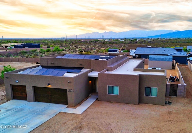 3335 E Canyoneer Pl, Vail, AZ 85641 - view of front of house featuring a mountain view, stucco siding, roof mounted solar panels, and concrete driveway