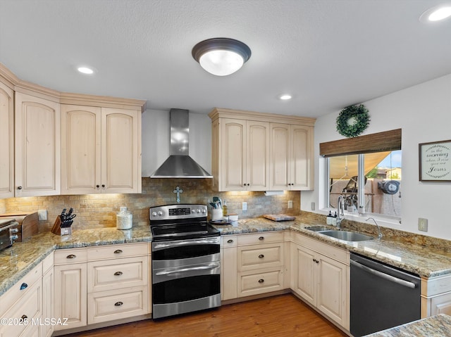 9880 E Cisco Ct, Tucson, AZ 85748 - kitchen featuring double oven range, wall chimney exhaust hood, dishwasher, a sink, and cream cabinetry