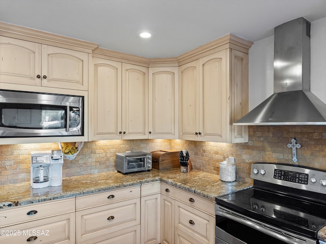 9880 E Cisco Ct, Tucson, AZ 85748 - kitchen with wall chimney exhaust hood, stainless steel appliances, cream cabinetry, tasteful backsplash, and light stone counters