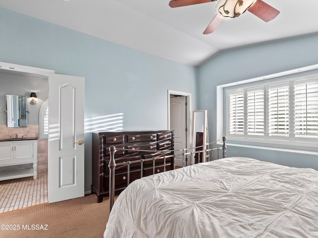 9880 E Cisco Ct, Tucson, AZ 85748 - bedroom featuring light carpet, lofted ceiling, ensuite bath, a sink, and ceiling fan