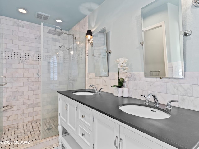 9880 E Cisco Ct, Tucson, AZ 85748 - bathroom featuring a stall shower, double vanity, and recessed lighting