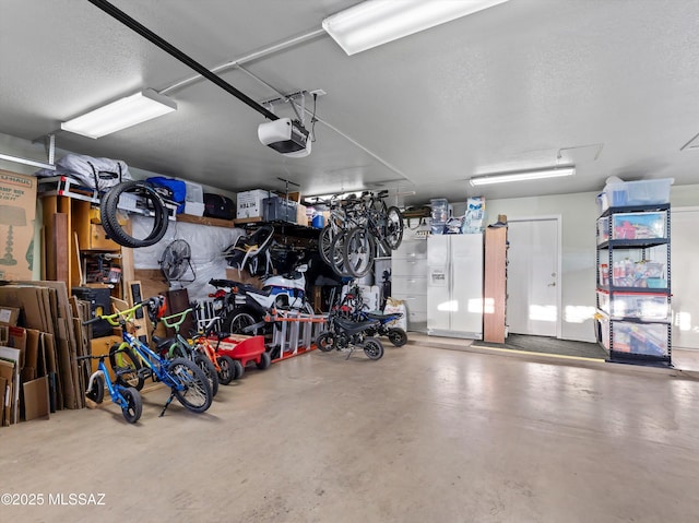 9880 E Cisco Ct, Tucson, AZ 85748 - garage featuring a garage door opener and white fridge with ice dispenser