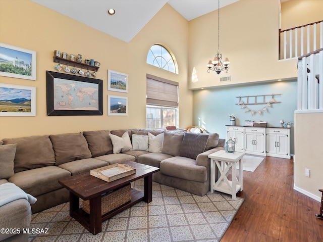 9880 E Cisco Ct, Tucson, AZ 85748 - living room with a chandelier, wood finished floors, high vaulted ceiling, and baseboards