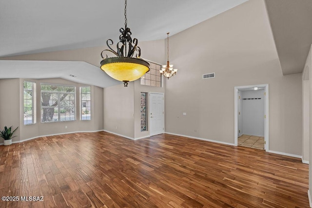 520 E Marshall Peak Dr, Oro Valley, AZ 85755 - unfurnished room with a chandelier, lofted ceiling, wood finished floors, and baseboards