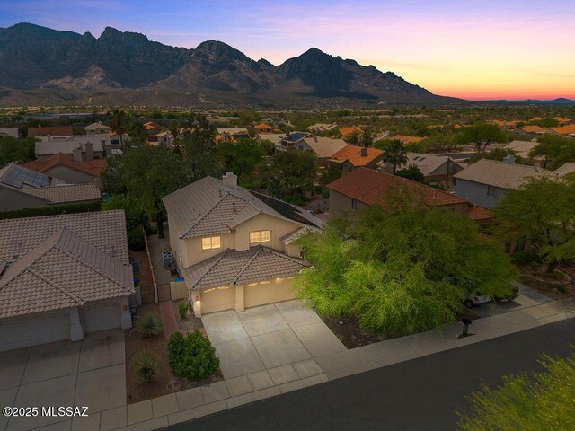 520 E Marshall Peak Dr, Oro Valley, AZ 85755 - aerial view at dusk of a residential view and a mountain view