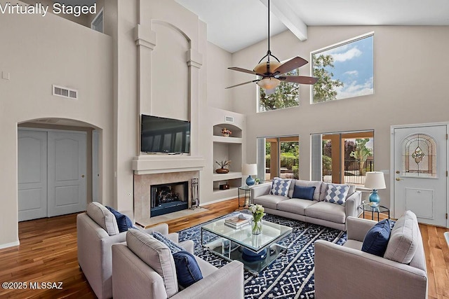 520 E Marshall Peak Dr, Oro Valley, AZ 85755 - living area with wood finished floors, beam ceiling, high vaulted ceiling, a ceiling fan, and arched walkways