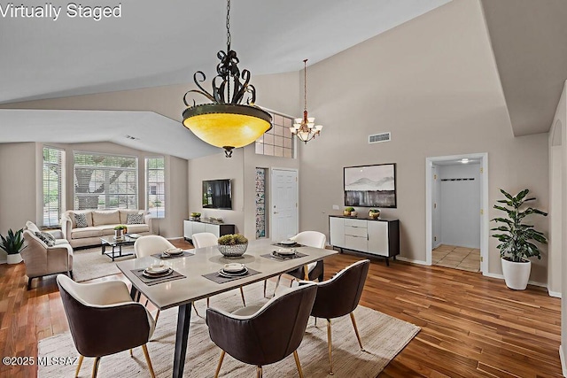 520 E Marshall Peak Dr, Oro Valley, AZ 85755 - dining room featuring lofted ceiling, a chandelier, wood-type flooring, and baseboards