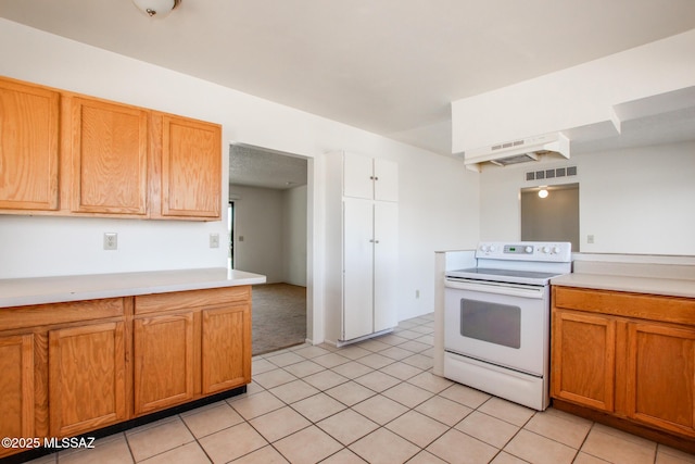9552 E Irene St, Tucson, AZ 85730 - kitchen featuring electric range, light countertops, and brown cabinets