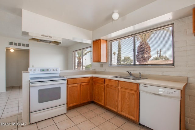 9552 E Irene St, Tucson, AZ 85730 - kitchen with white appliances, light tile patterned floors, a sink, and light countertops
