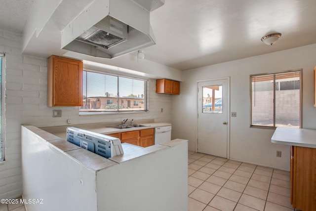 9552 E Irene St, Tucson, AZ 85730 - kitchen with a sink, white dishwasher, light tile patterned floors, light countertops, and brown cabinets