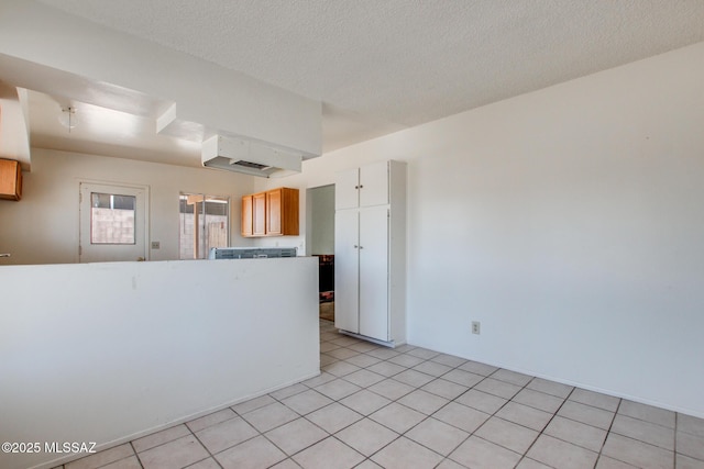 9552 E Irene St, Tucson, AZ 85730 - kitchen with a textured ceiling and light tile patterned floors