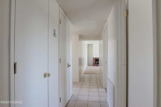 9552 E Irene St, Tucson, AZ 85730 - hallway featuring a textured ceiling and light tile patterned floors