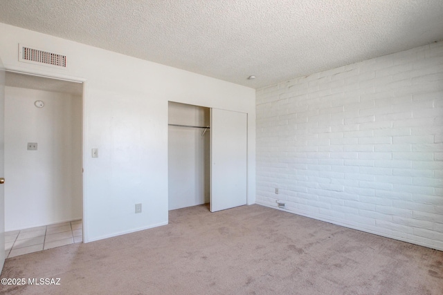 9552 E Irene St, Tucson, AZ 85730 - unfurnished bedroom featuring carpet flooring, a textured ceiling, and a closet