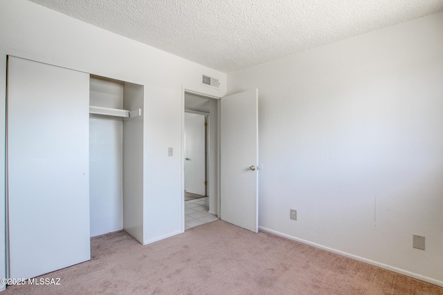 9552 E Irene St, Tucson, AZ 85730 - unfurnished bedroom featuring carpet floors, a closet, and a textured ceiling