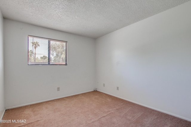 9552 E Irene St, Tucson, AZ 85730 - unfurnished room with light colored carpet, baseboards, and a textured ceiling
