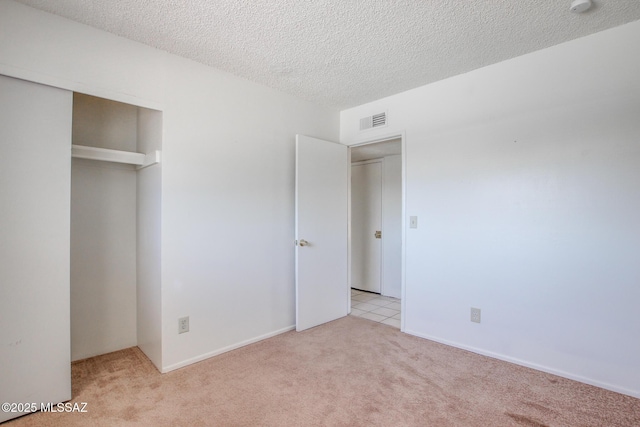 9552 E Irene St, Tucson, AZ 85730 - unfurnished bedroom featuring light colored carpet, a textured ceiling, and a closet